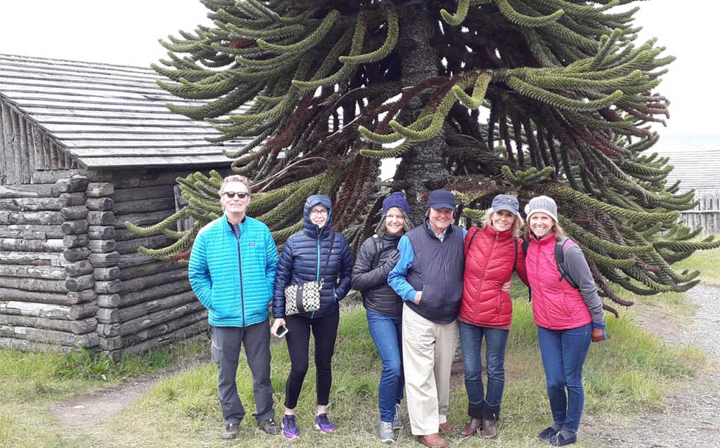 Guests at Fort Bulnes with monkey pine tree