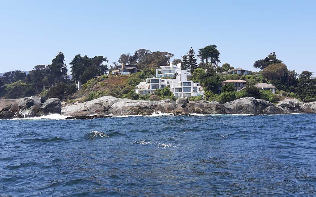 Mansions seen during boat ride to Penguin Island in Cachagua