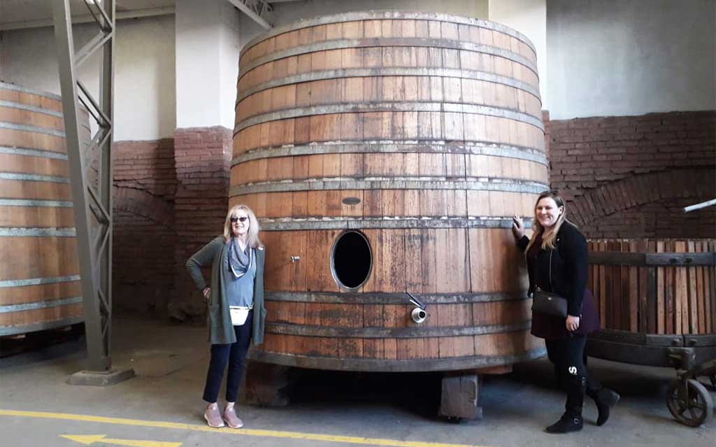 Guests next to large wine barrel at Viña Santa Rita